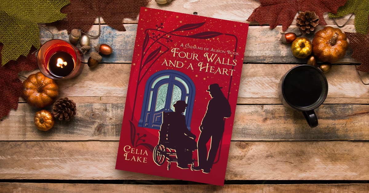 Four Walls and a Heart lying on a table with autumn gourds. The cover is a deep red, with a man in a wheelchair and a man standing, both in silhouette, in front of a large blue and glass door.