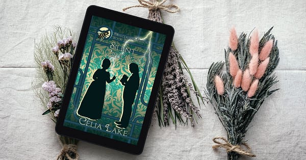 Silent Circuit displayed on a tablet on a table with dried lavender and other flowers. The cover has a silhouetted man and woman in Victorian dress face each other. He is holding a book open for her, as her hand moves to turn a page. They’re on a background of green damask with green pipes, a streak of lightning behind them. A bee is inset on top of a gear in the top left.